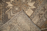 Folded corner of a vintage Kars carpet showing its hand-knotted back and low, even pile.