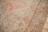 Detailed view of the distressed texture and geometric border in rust and dusty blue tones.