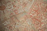 Close view of the machine-bound side and distressed, low-pile texture of a vintage Shiraz carpet.
