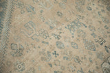 Low pile and hand-knotted texture of a distressed Qashqai carpet with dusty blue floral motifs.