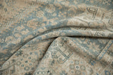 Softly folded vintage Qashqai carpet showing its time-softened texture and low pile.