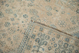 Detail of the hand-knotted foundation and low pile on a distressed Qashqai carpet's folded corner.