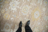 Distressed Afghani Oushak carpet close-up, showing nuanced palmettes and soft, muted colors.