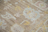 Distressed Afghani Oushak carpet texture, with soft blue, yellow, and mauve motifs.