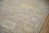 Distressed beige Afghani Oushak rug, showing wear, subtle patterns, and intact side cord selvage.