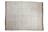 Distressed Afghani Oushak design carpet, hand knotted with faded platinum, ivory, and saffron patterns.