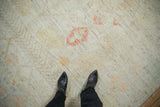 Distressed Afghani Moroccan carpet texture showing faded ivory, green, and madder root red patterns.