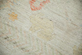 Close-up of distressed ivory pile, revealing visible knot heads and subtle saffron, red, and green hues.