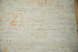 Distressed Afghani Moroccan carpet texture showing even pile wear and faded pastel tones.