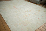 Close-up of distressed Afghani Moroccan carpet pile, showing even wear and faded plant motifs.