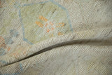 Distressed ivory pile of Afghani Moroccan rug, showing visible knot heads and faded colors.