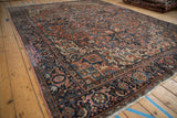 Vintage Heriz carpet: brick red geometric floral field, navy blue turtle samovar border.