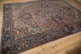 Vintage Heriz carpet corner detail, showing navy blue turtle samovar border with pink selvage.