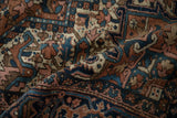 Vintage Heriz rug pile with geometric blossoms, vinery in brick red, navy, and pink.