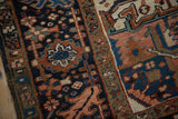 Vintage Mehrivan rug detail showing the navy field and serrated leaf border design.
