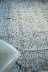 Distressed ivory texture with faded allover floral motifs on a vintage Oushak rug.