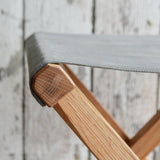 Slate waxed canvas seat detail on the reclaimed oak frame of the expedition stool.