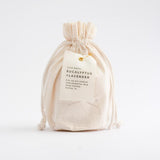 Natural canvas drawstring bag with Eucalyptus and Lavender Soy Candle label.