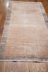 Vintage Oushak runner featuring a distressed two-tone beige pile and charcoal border.