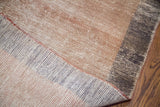 Distressed beige and charcoal pile, revealing the hand-woven foundation of the Oushak runner.