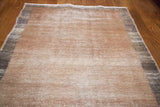 Distressed beige and charcoal tones with visible hand-knotted texture.