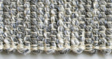 Detail of the hand-woven cotton texture with undulating shades of gray and off-white yarn.
