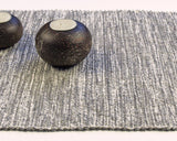 Textured weave of the handwoven cotton runner showing undulating gray shades.