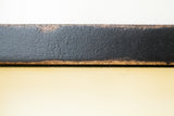 Edge detail of the black handmade frame showing its vintage textured finish.