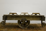 Miniature industrial cart, side view, showing torched wood with black antique metal casters.