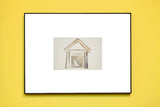 Collage art print of antique photographs in a house shape with a central cat image.