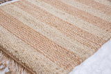 Hand-woven jute texture of the Honey rug, showcasing natural light and warm honey stripes.