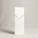 Rectangular porcelain vase with a smooth top, textured bottom, and a thin V-shaped gold accent line.