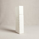 A 22k gold line accents the division of smooth and crawling textured white porcelain.