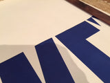 Crisp blue letters on the Mid Century We Like Ike political poster.