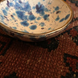 Handmade white and indigo dish with speckled crystal glazes and silver lustre rim.