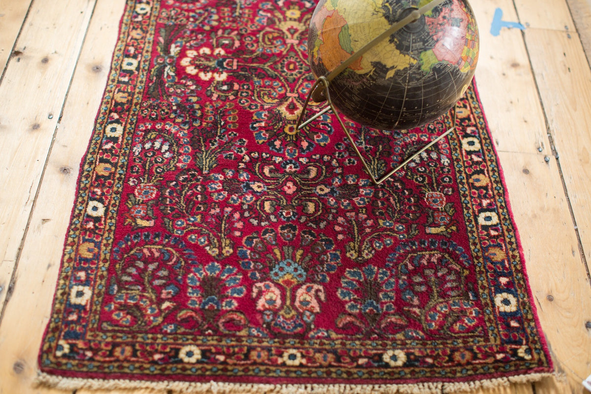 Bold burgundy vintage Persian Sarouk rug with intricate floral design, 2'5" x 4'9".