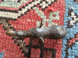 Vintage brass African elephant casting with rich patina and surface markings.