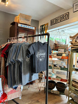 Kids charcoal Katonah New York t-shirt displayed on a clothing rack in-store.