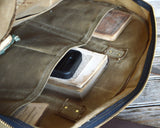 Peg and Awl Journey Duffle Bag's moss green waxed canvas interior with multiple organized pockets.