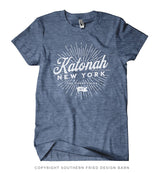 Unisex light blue heathered tee with white Katonah New York 'Finest Folks' sunburst graphic.