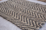 Braided Kema Collection jute rug featuring a grey and natural herringbone pattern.