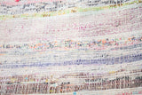 Vintage rag rug's soft wool texture showing varied ivory, blue, and charcoal dashes.