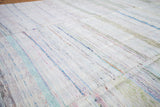 Textured wool rag rug detail, showing sewn sections and colorful stripe dashes.