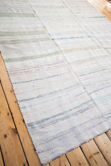 Vintage rag rug close-up, highlighting the woven texture, subtle stripes, and visible seam.