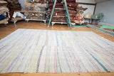 Soft vintage rag rug carpet with ivory ground, colorful vertical stripe dashes, constructed in three sections.