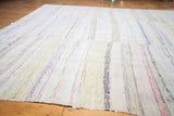 Soft wool texture and colorful striped dashes of the vintage rag rug.