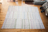 Soft woven vintage rag rug with vertical stripe dashes in ivory and pastels.
