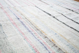 Soft vintage rag rug texture with ivory, blue, pink, and charcoal stripe dashes.