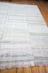 Soft woven texture of a vintage rag rug, with horizontal stripes of ivory, blue, and pink.