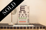 Graham Field eye chart light box and antique silver-toned shaving mirror.